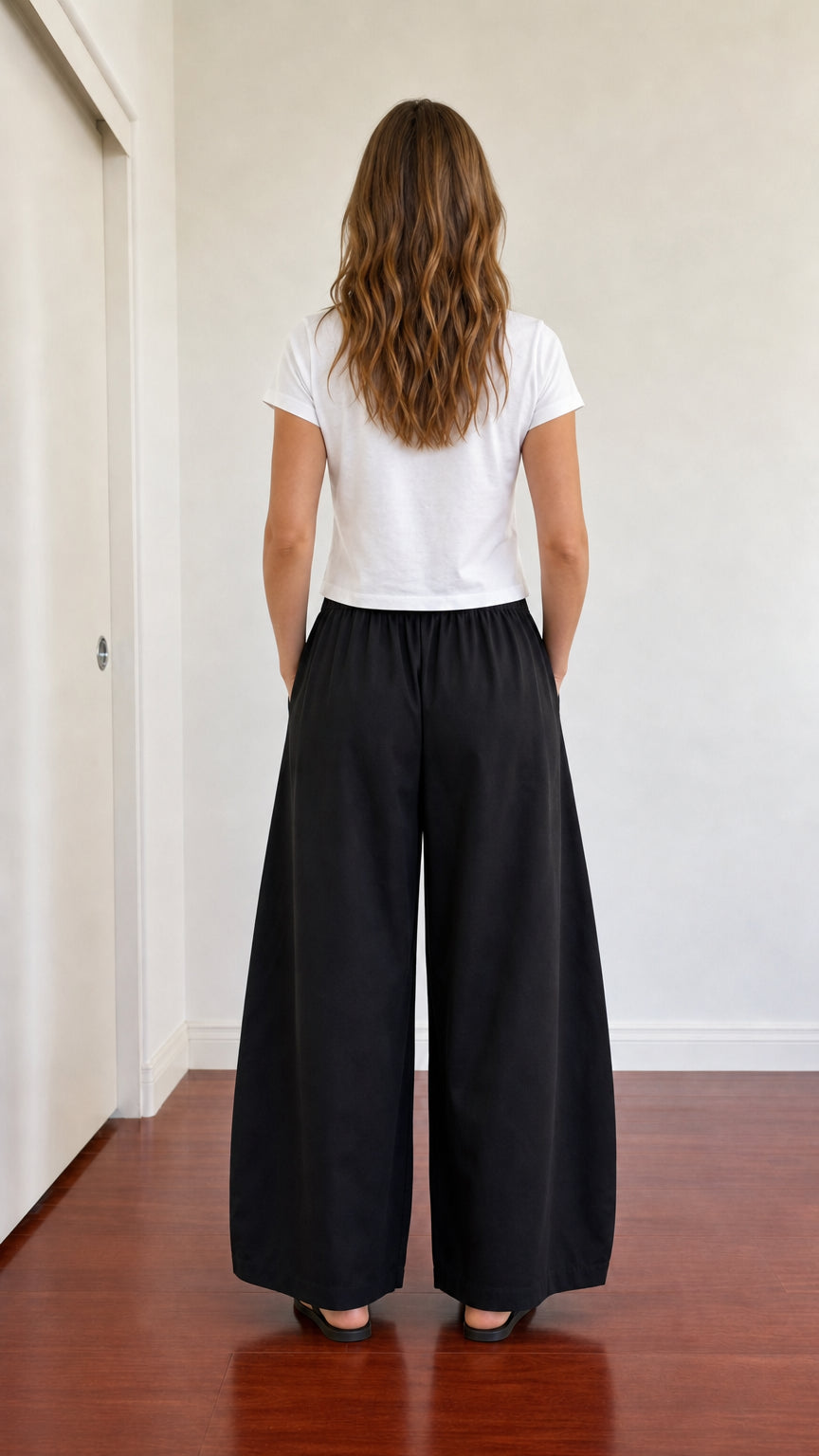 Back view of model wearing full-length black wide leg lounge pants